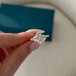 Marquise three-stone diamond engagement ring with marquise and round side stones