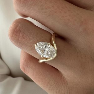 Elegant oval solitaire engagement ring with polished bypass band