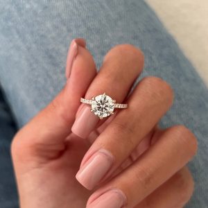 Round pavé diamond engagement ring with raised gallery and thin band