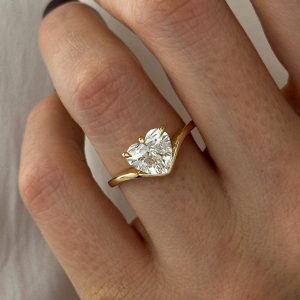 Heart-shaped solitaire engagement ring with split curved shank and three-prong setting