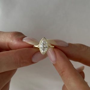 Marquise bezel solitaire engagement ring with split shoulder band