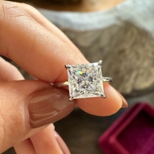 Princess cut solitaire engagement ring with hidden halo and plain polished band