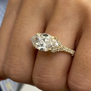 Marquise diamond engagement ring with pavé set accent stones and six prong setting
