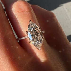 Marquise diamond engagement ring with pavé band and ornate cathedral gallery