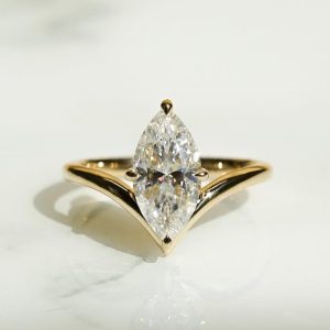 Marquise solitaire engagement ring with split, tapered band and 6-prong basket setting