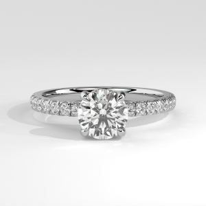 Round hidden halo pavé engagement ring with four-prong setting and diamond accents
