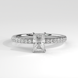Radiant cut engagement ring with pavé diamond band and four-prong basket setting