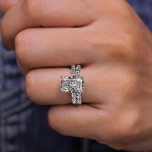 Radiant cut engagement ring with hidden halo and matching diamond eternity band