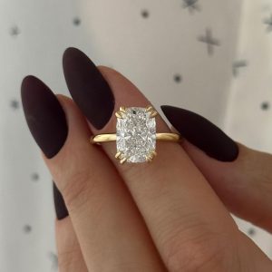 Cushion-cut engagement ring with hidden halo and polished plain band