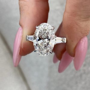 Oval three-stone engagement ring with tapered baguette sides
