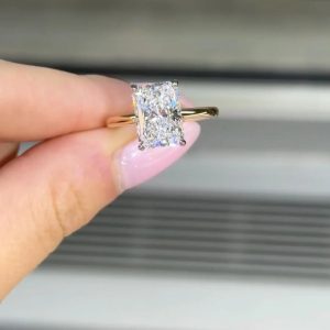 Radiant cut engagement ring with hidden halo and polished plain band