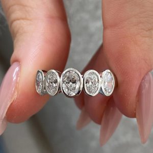 Five oval bezel-set stones on a polished band, side-by-side view