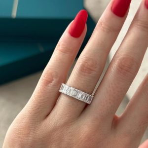 Eternity band with rectangular step-cut stones in shared prong setting