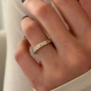Eternity band with rectangular step-cut stones set in channel segments around the band
