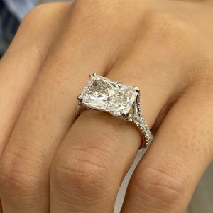 Radiant cut diamond engagement ring with pavé band and cathedral setting