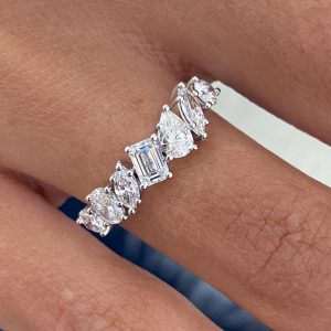 Five stone diamond ring with emerald center, ovals and pears in shared prong setting