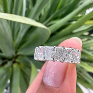 Full eternity band with rectangular radiant or cushion cut stones in a shared prong setting