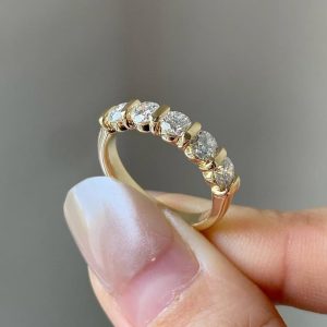 Five-stone round diamond ring with shared prong setting and tapered band
