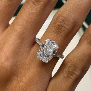 Rectangular cushion engagement ring with pavé band and hidden halo in basket setting