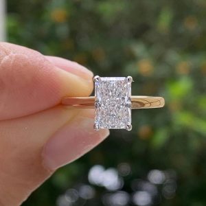 Radiant cut engagement ring with hidden halo and polished band