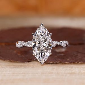 Marquise diamond engagement ring with twisted pavé band and hidden halo