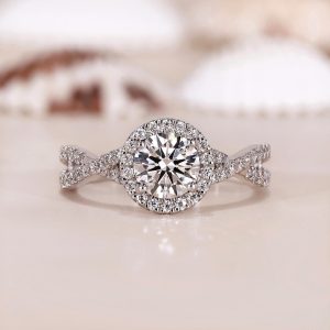 Round halo engagement ring with split pavé shank and decorative gallery