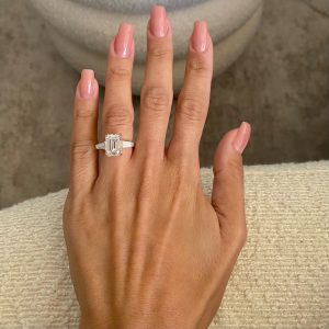 Emerald cut diamond three-stone engagement ring with tapered baguette side stones