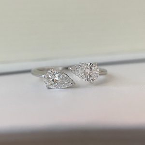 Modern ring with two opposing pear-shaped stones on an open polished band