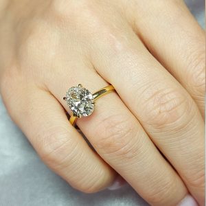 Elegant oval halo engagement ring with plain band in yellow tone