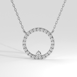 Open circle diamond pendant with pear-shaped diamond accent on a fine chain