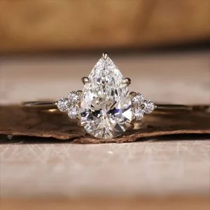 Oval three stone engagement ring with polished band and open gallery